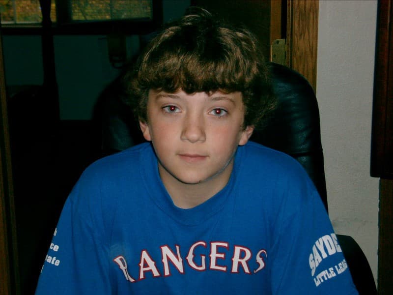 A photo of me in front of the family desktop computer in 2006, likely playing RuneScape